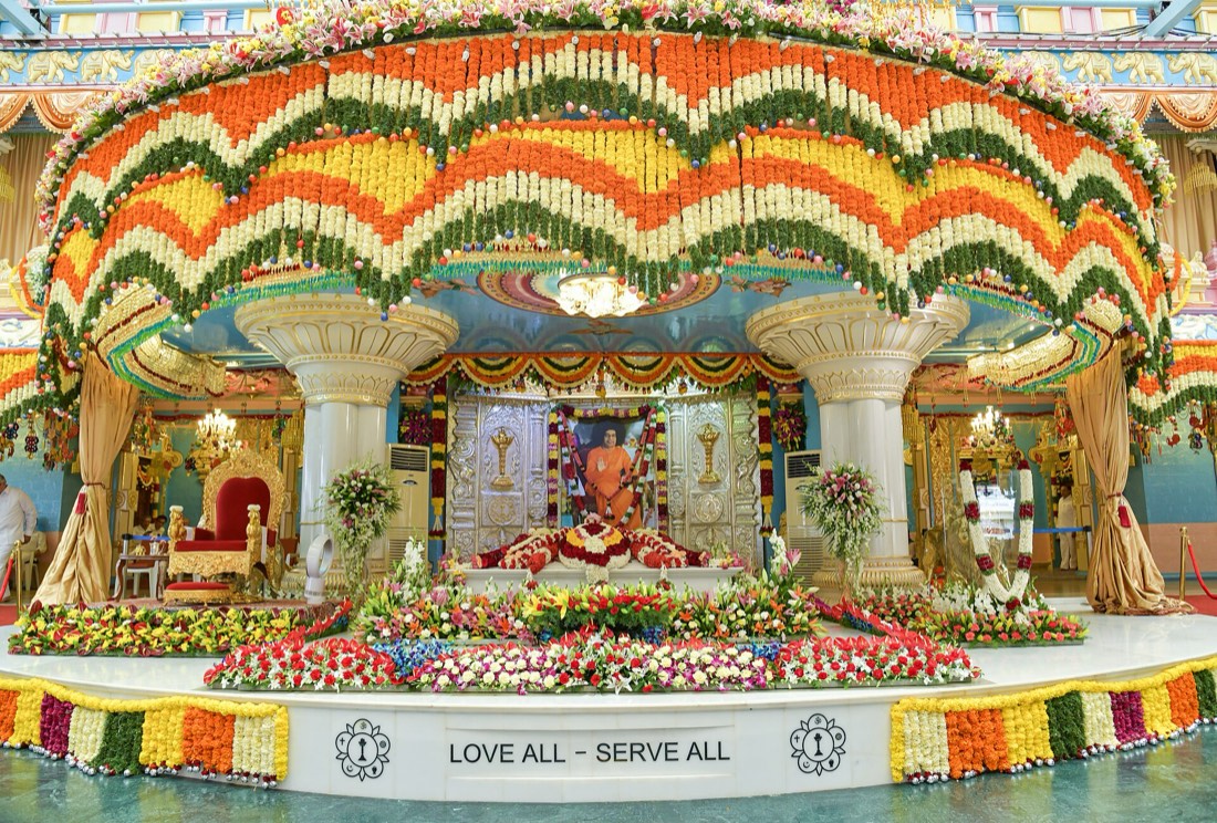 The Mahasamadhi dressed in flowers at Sai Kulwant Hall (photo: Venkatant, Wikimedia Commons, CC BY-SA 4.0).